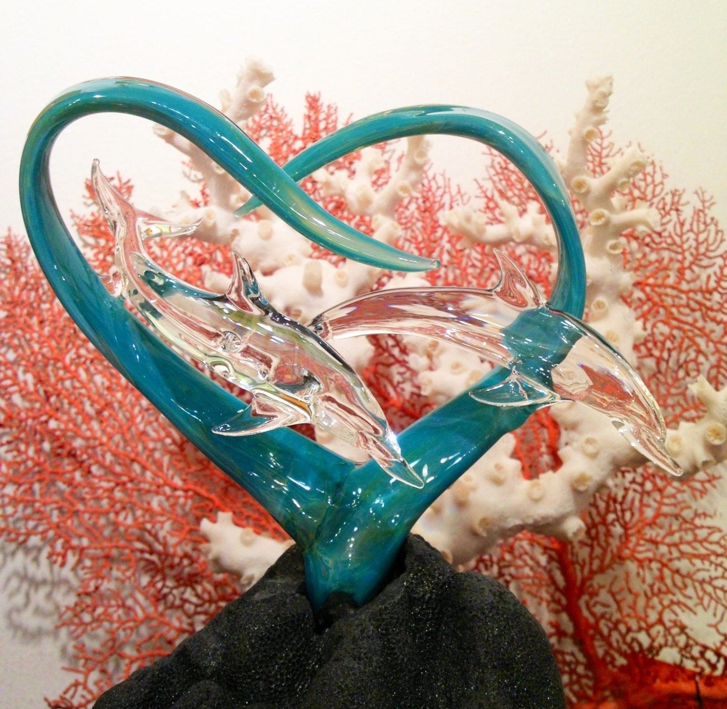 Dolphins in a heart glass sculpture