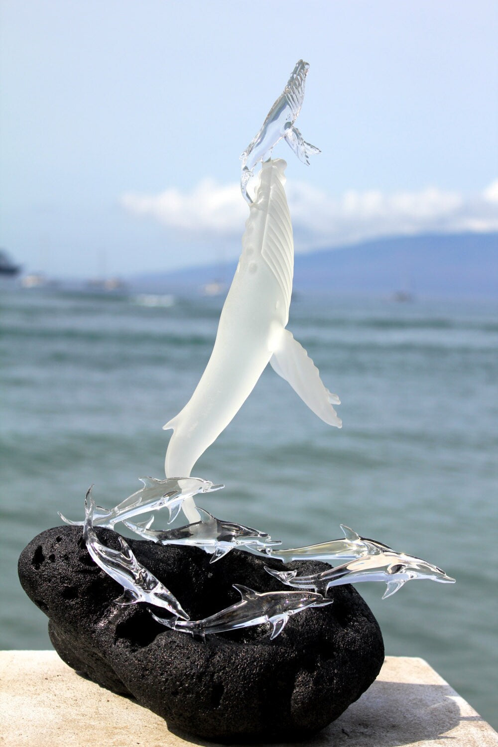 Whales first breath with dolphins glass sculpture