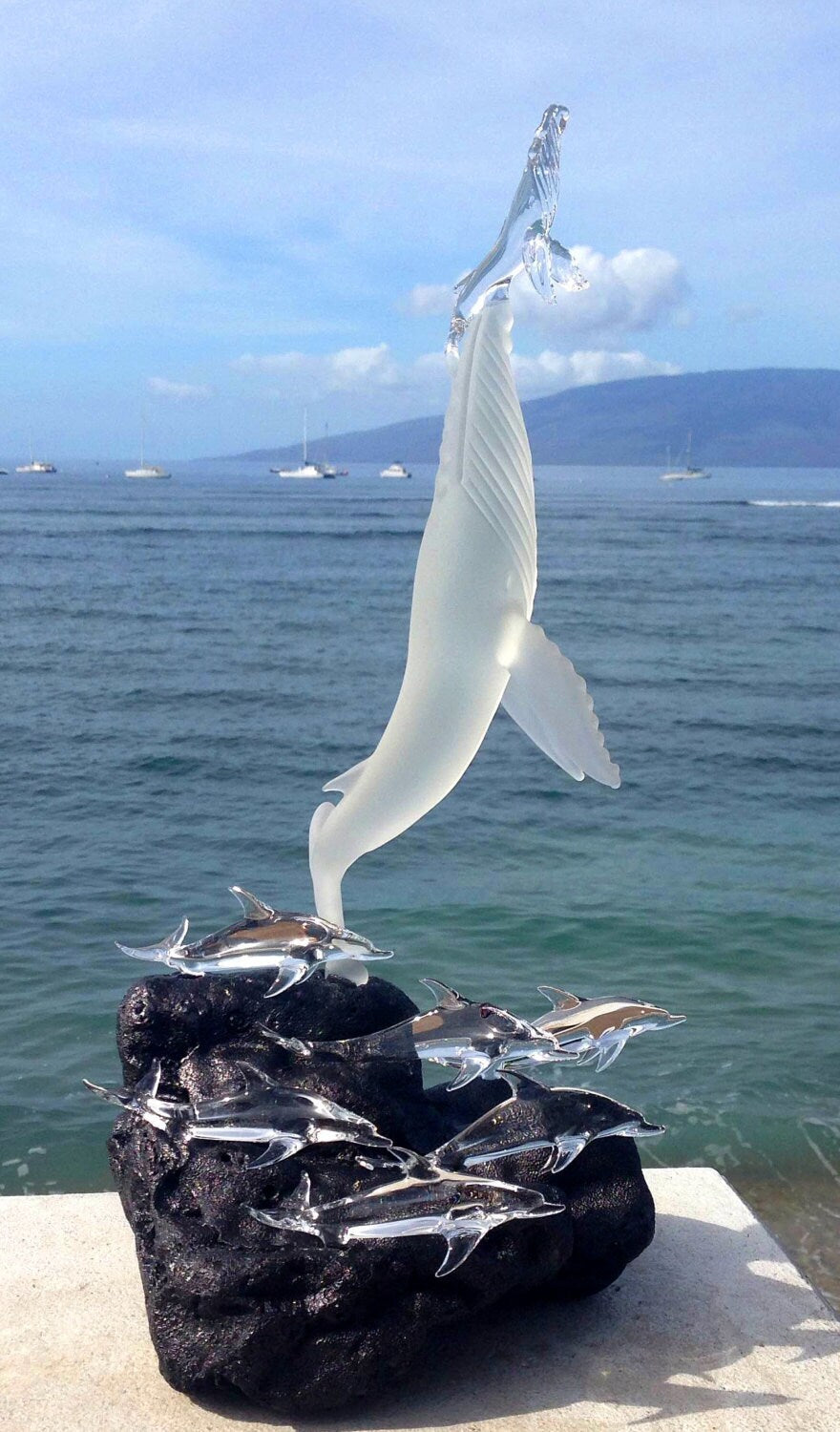 Whales first breath with dolphins glass sculpture