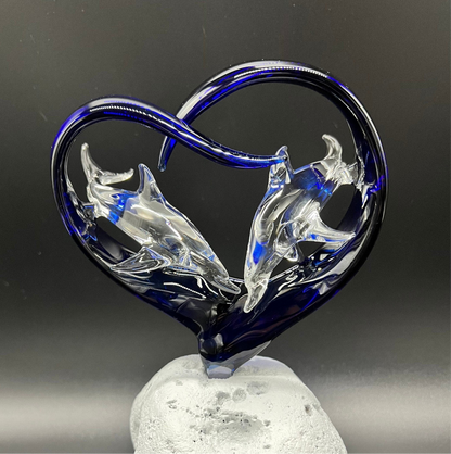 Two dolphins in a cobalt heart glass sculpture