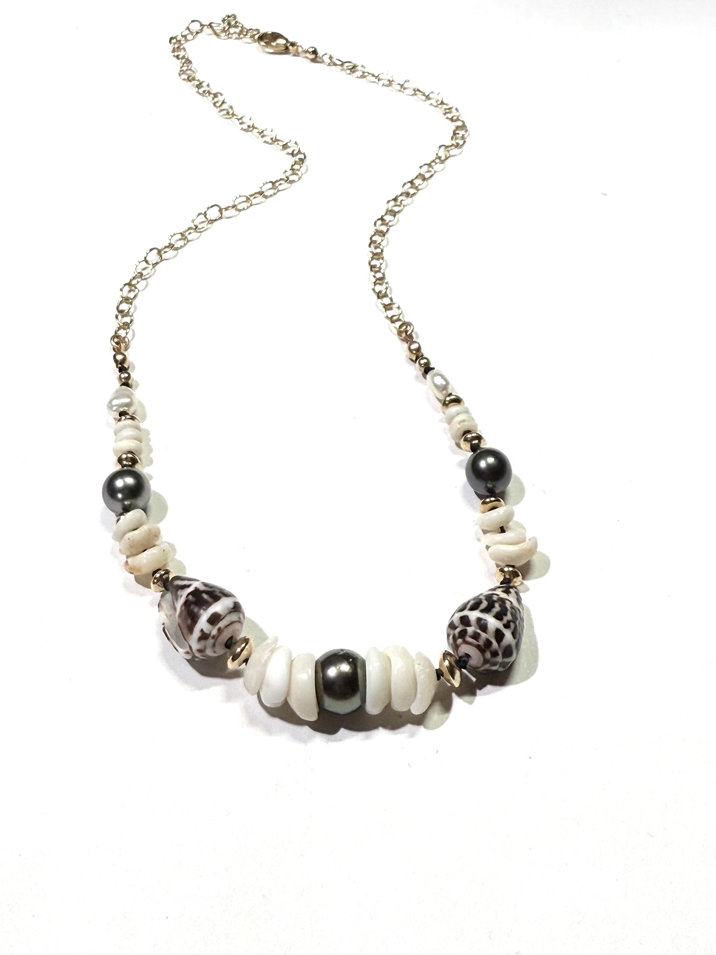 Tahitian pearls, cone shells, and puka shells necklace