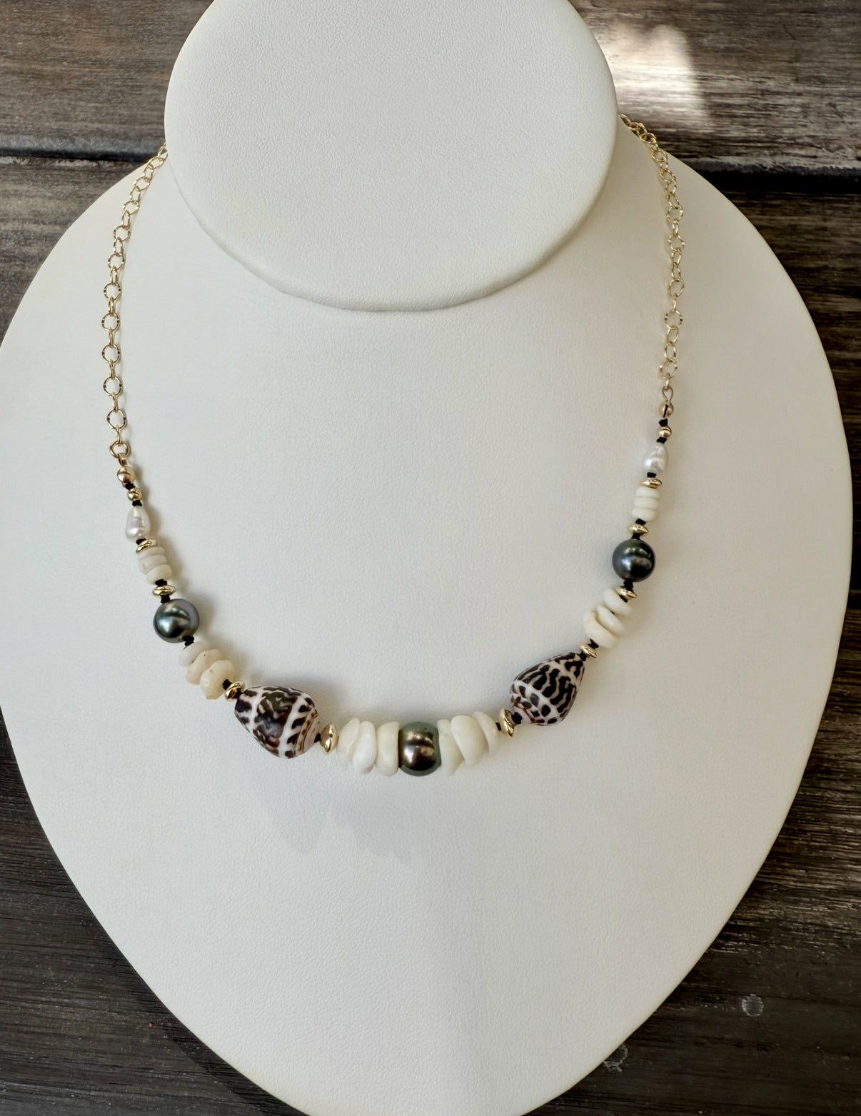 Tahitian pearls, cone shells, and puka shells necklace