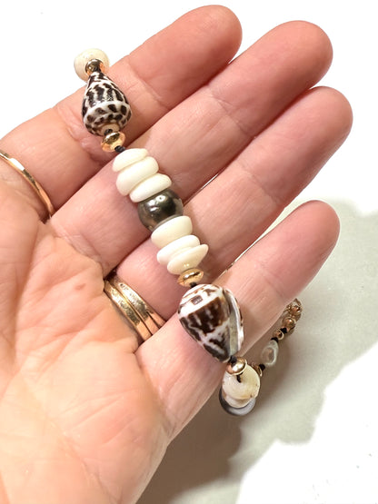 Tahitian pearls, cone shells, and puka shells necklace